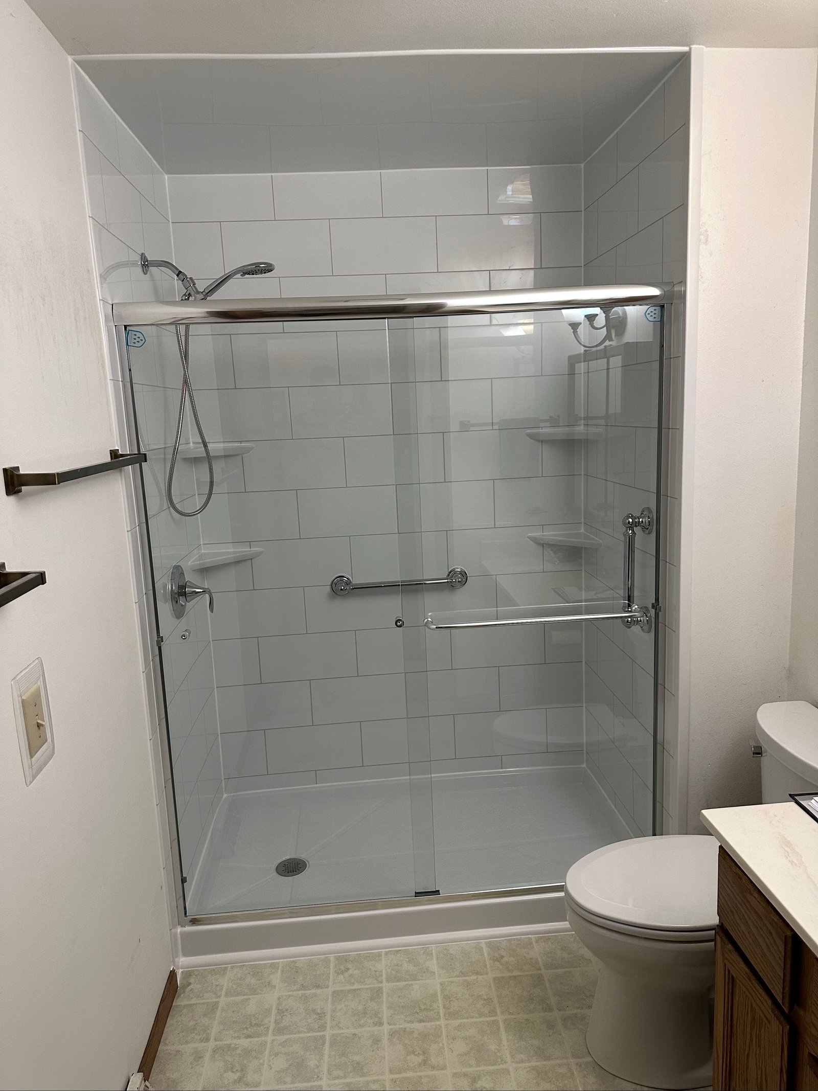 Walk-in shower with white subway tile and chrome fixtures in Wisconsin