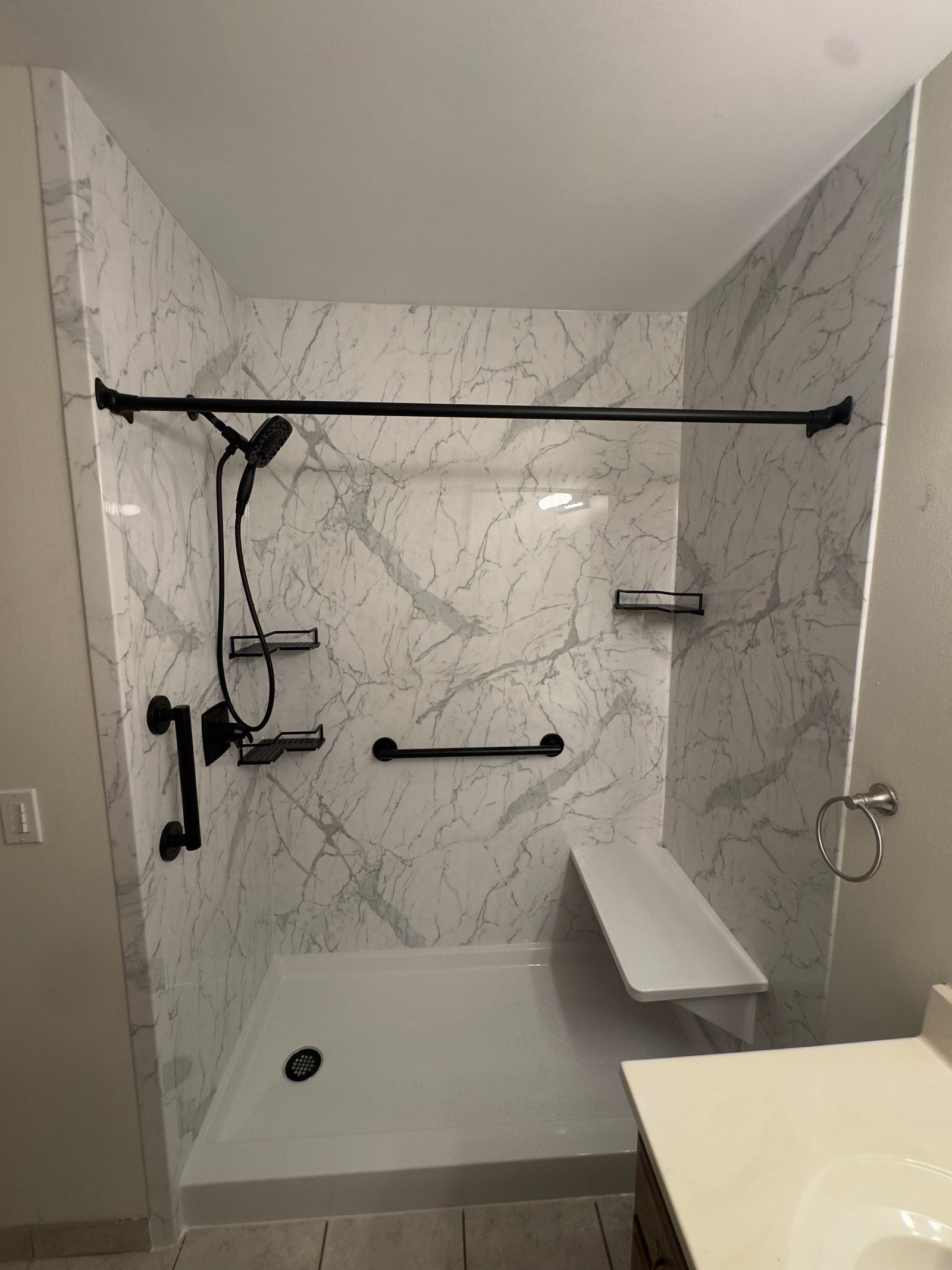 Modern walk-in shower with glass doors and white subway tile in Wisconsin