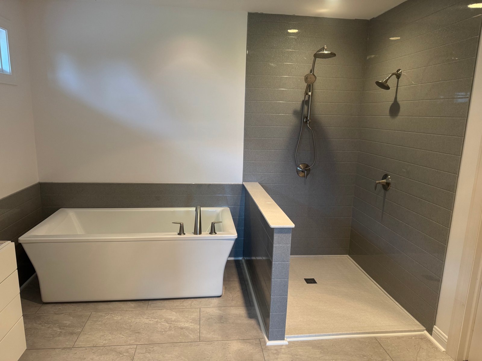 Modern walk-in shower with white marble walls and matte black fixtures in Wisconsin