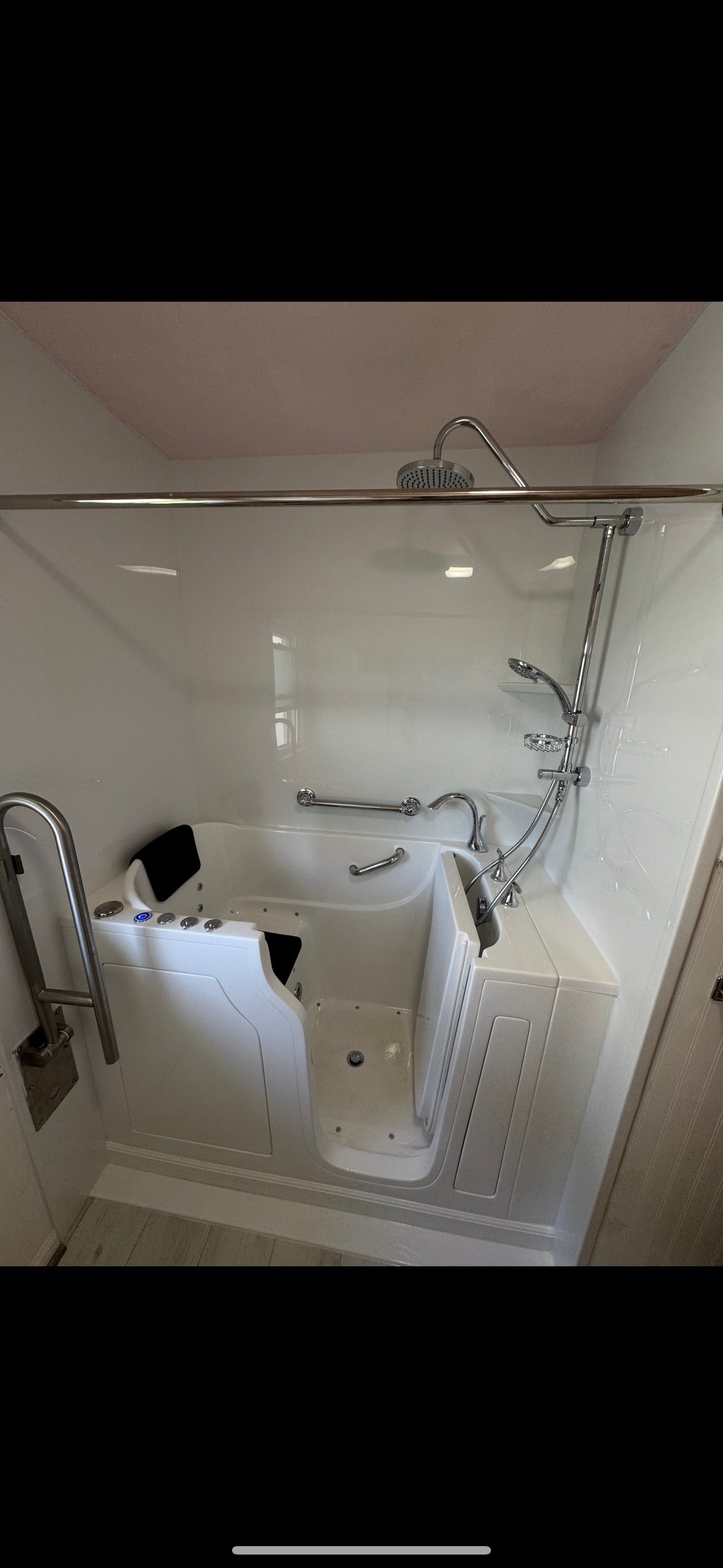 Walk-in shower with black frame and white subway tile in Wisconsin