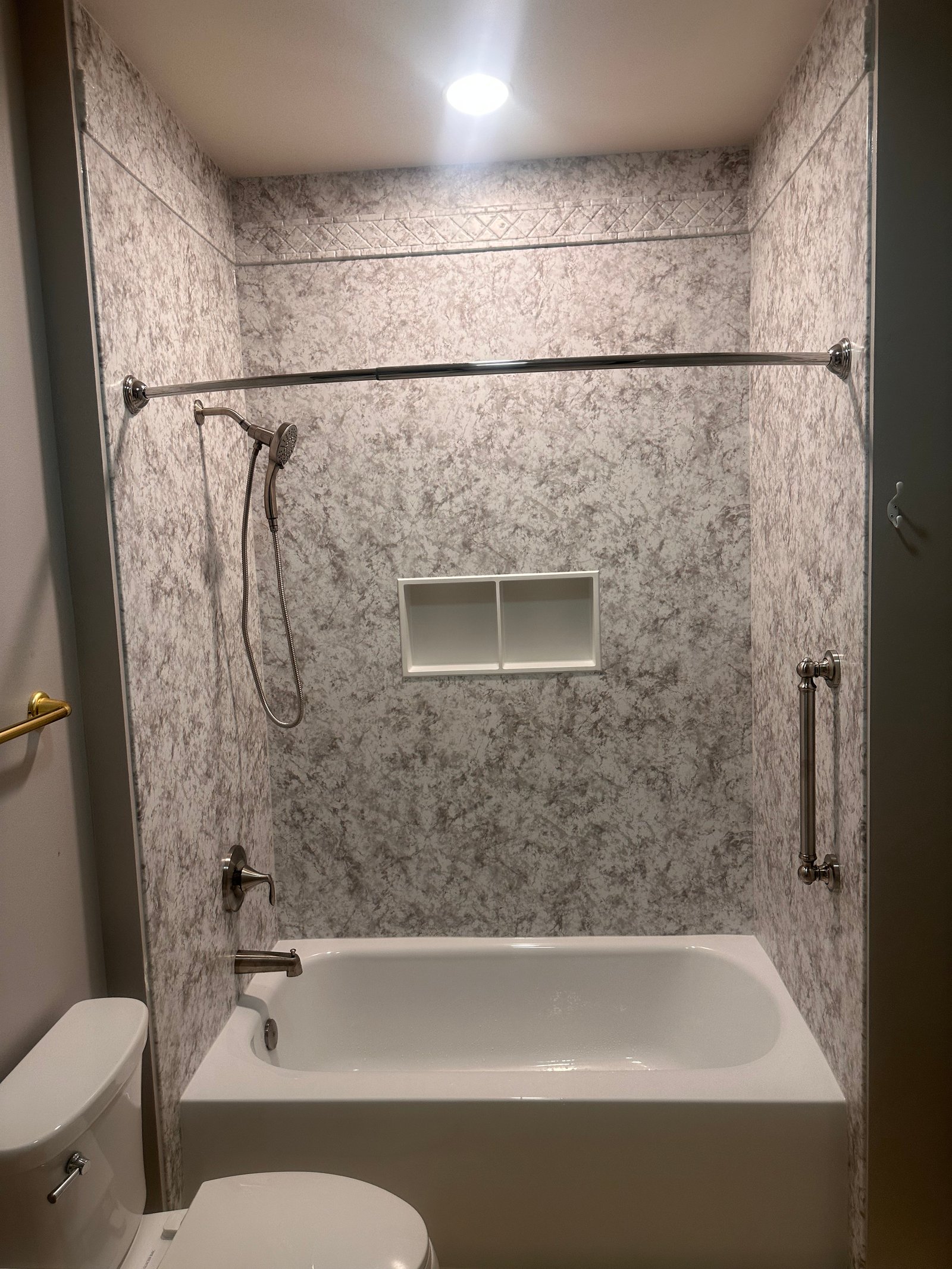 Bathtub and shower with white subway tile and matte black fixtures in Wisconsin