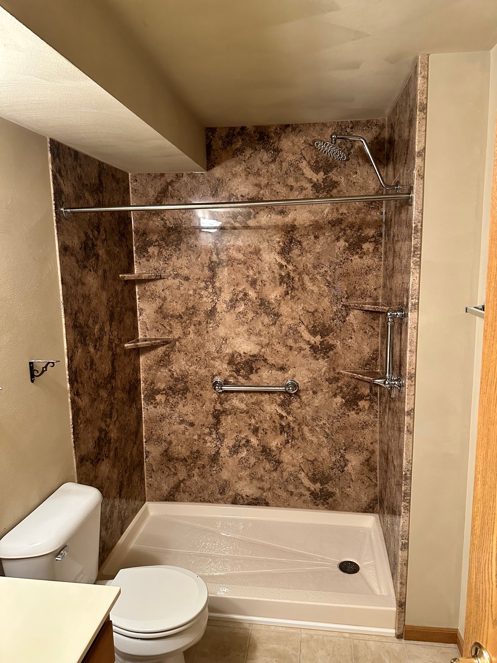 Modern shower with white subway tile and dark grout in Wisconsin